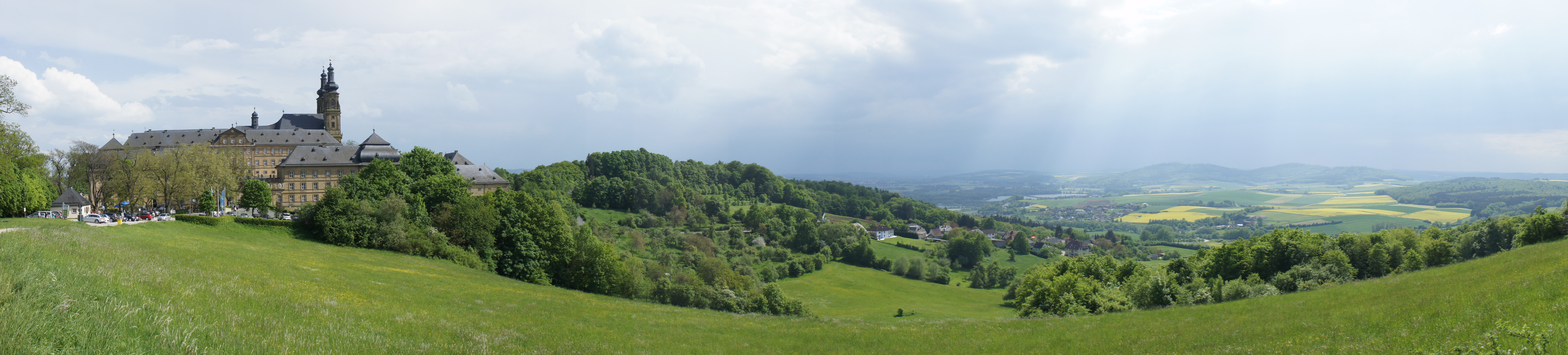 Panorama of mountains, a town, and fields far into the distance